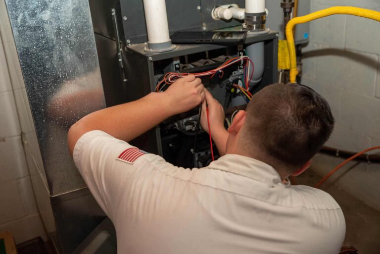 calfo employee performing a furnace repair in pittsburgh pa